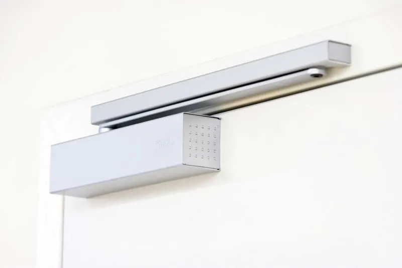 Types of door closers

The many different types of door closers can be placed in one of two categories, namely closers with a hold-open function and closers without a hold-open function.

Closers with a hold-open function will hold a door open once it has been opened beyond a certain angle, which is not the best choice if you’re looking to improve security and fire prevention and control. Closers without a hold-open function will automatically close the door, regardless of the angle of the door.
