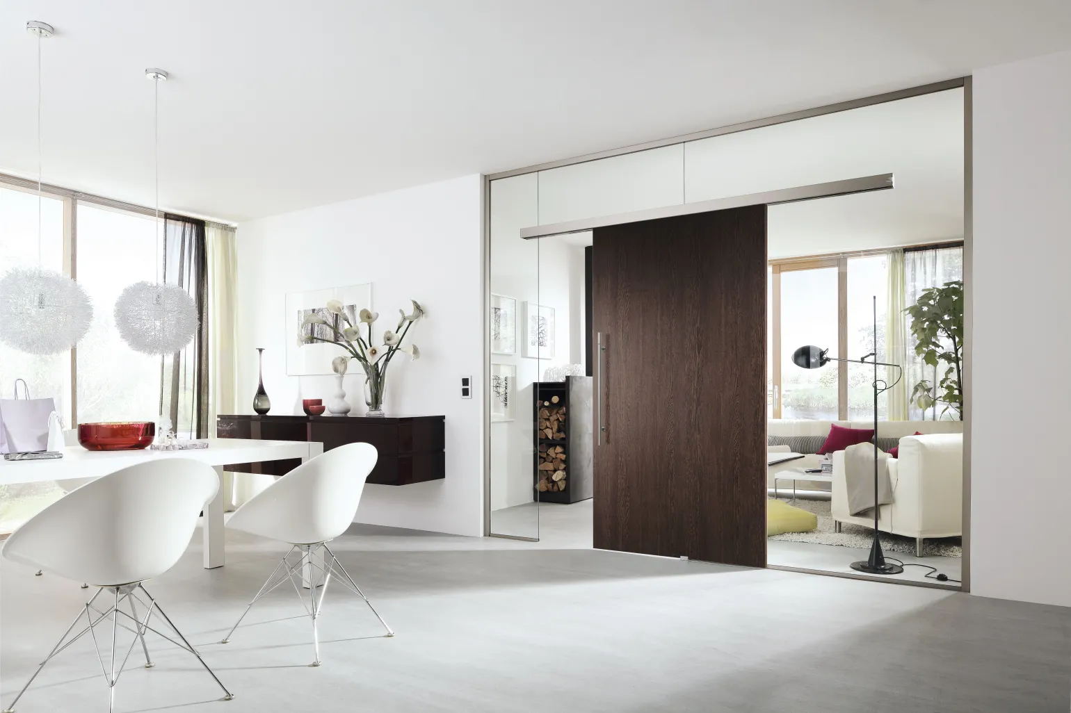 Before continuing, let’s clarify what we mean by the term ‘internal sliding doors.’ Whether made of glass, wood, or another material, these sliding doors slide open and closed on a track or rail. Usually, a single track is mounted above the door. A piece of hardware known as a hanger connects the door panel to the track. The hanger’s roller allows it to move on the track. Rails can also be installed at the bottom of the door, or the sliding door frame may extend to the ground and the door may slide along the frame.
