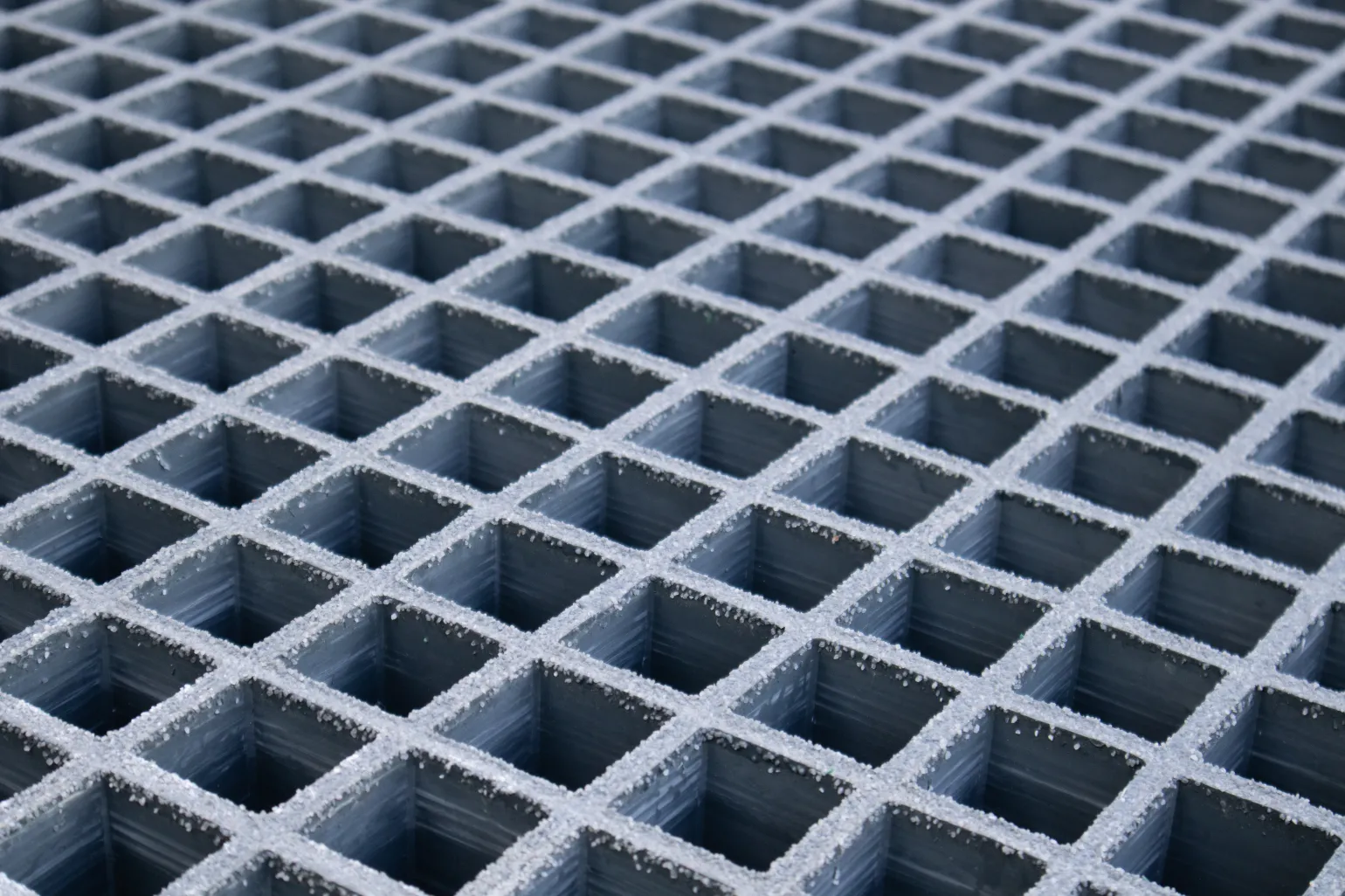 What Is GRP Grating?

GRP grating systems are made by combining resin with glass fibres, the latter of which are laid out in a mesh grid pattern and then reinforced with resin to create a robust and highly long-lasting result.

This form of grating is known for being up to 75% lighter in weight than steel mesh grating, making it simpler to transport, handle, and install. It is also strong, and can support heavier loads, and it offers corrosion and rust resistance, making it well suited to installation in harsh facilities. Moreover, GRP grating can be fitted with gritted surfaces to provide slip resistance, and is chemical resistant as well, enabling its use in a variety of industrial settings.
