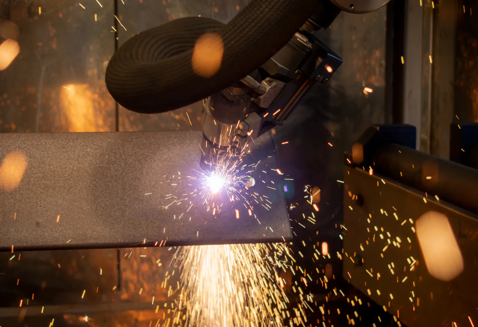 Discover the precision of the Coping Line at BM Steel! We specialise in delivering custom steel solutions with cutting-edge technology, ensuring your materials are crafted to exact specifications. From structural beams to intricate shapes, we've got you covered.
The RPC 1200 Mk3 is world's first beam coping robot. This all-in-one solution created by the industry leader in thermal 3D cutting is the most versatile beam cutting solution available in the market. It offers high speed plasma cutting of ready-to-fit parts prepared for any desired connection; both welded and bolted. The RPC sets a new standard by offering an entire fabrication shop in a single machine.
Developed to practically elimitate the need for finishing by grinding plus a reconfigured plasma process to address your needs, this versatile machine capable of a wide range of cutting tasks and is ideal for your next steel project. Using a 360° robotic arm with laser-accurate measurements and Kjellberg Hi Focus Plasma technology, the RPC Coping Line can perform an plethora of tasks efficiently & precisely helping handle any of your steel cutting needs, regardless of the complexity of your project.
Learn more about how we can support your next project below!